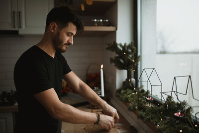 Young man looking at camera at home