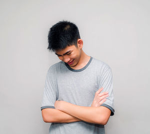 Smiling boy standing against white background