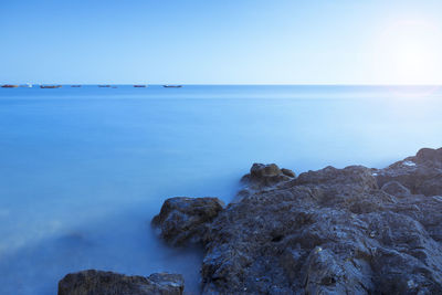 Scenic view of sea against clear blue sky