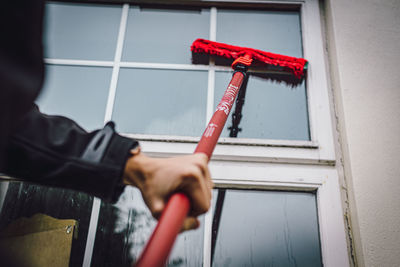 Man working on red wall