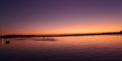 Scenic view of sea against romantic sky at sunset