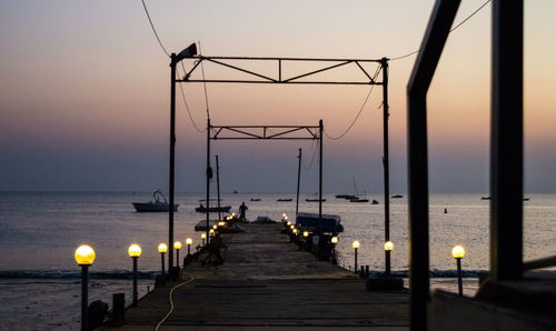 Pier on sea at sunset