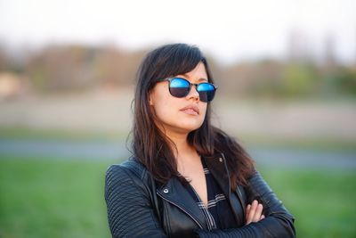 Portrait of young woman wearing sunglasses outdoors