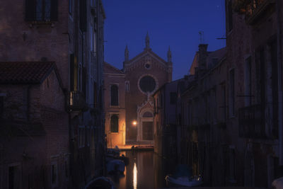 Low angle view of illuminated building against sky at dusk