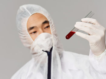 Scientist holding blood samples in test tube