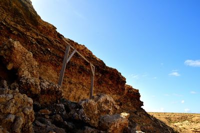 Low angle view of rock formation against sky