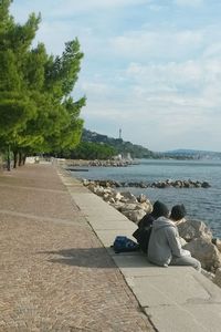 Tourists sitting on beach
