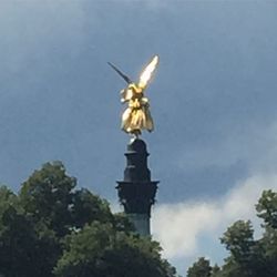 Low angle view of bird statue against sky