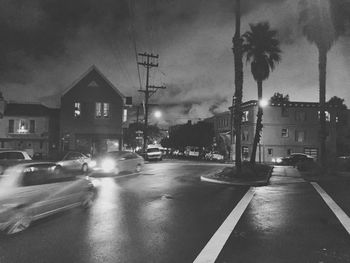 City street against sky at dusk