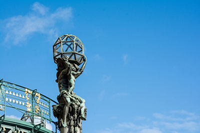 Low angle view of statue against blue sky