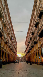 Street amidst buildings in city against sky