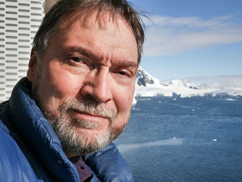 Close-up portrait of man against frozen sea