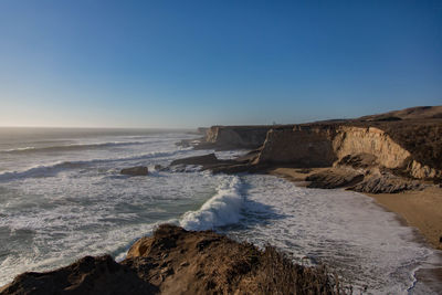 Scenic view of sea against clear blue sky