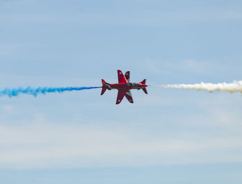 Low angle view of airplane flying against sky