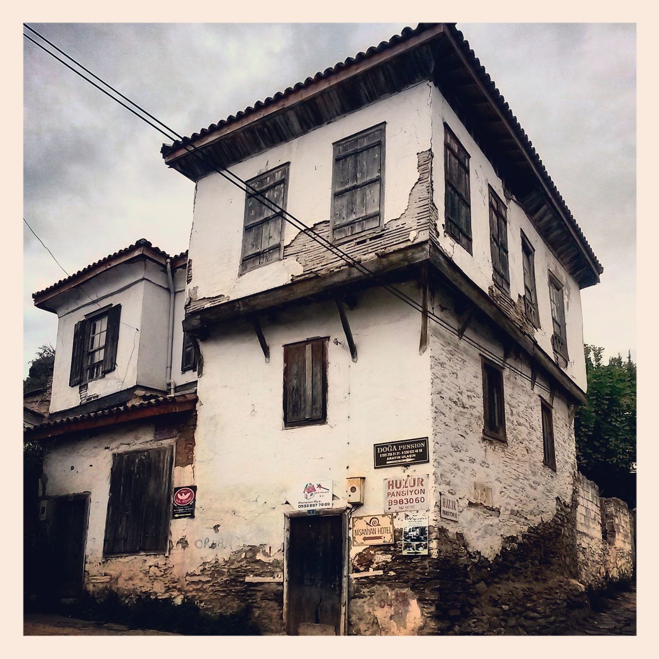 architecture, building exterior, built structure, transfer print, sky, low angle view, window, auto post production filter, building, residential structure, residential building, house, cloud - sky, old, day, city, exterior, outdoors, brick wall, cloud