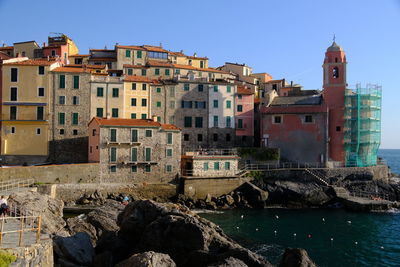 Buildings in city against clear sky