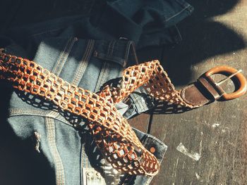 High angle view of jeans and belt on floor