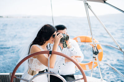 People sailing on sailboat in sea