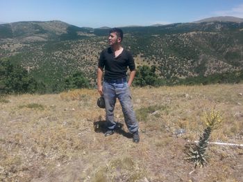 Full length of young man standing on mountain