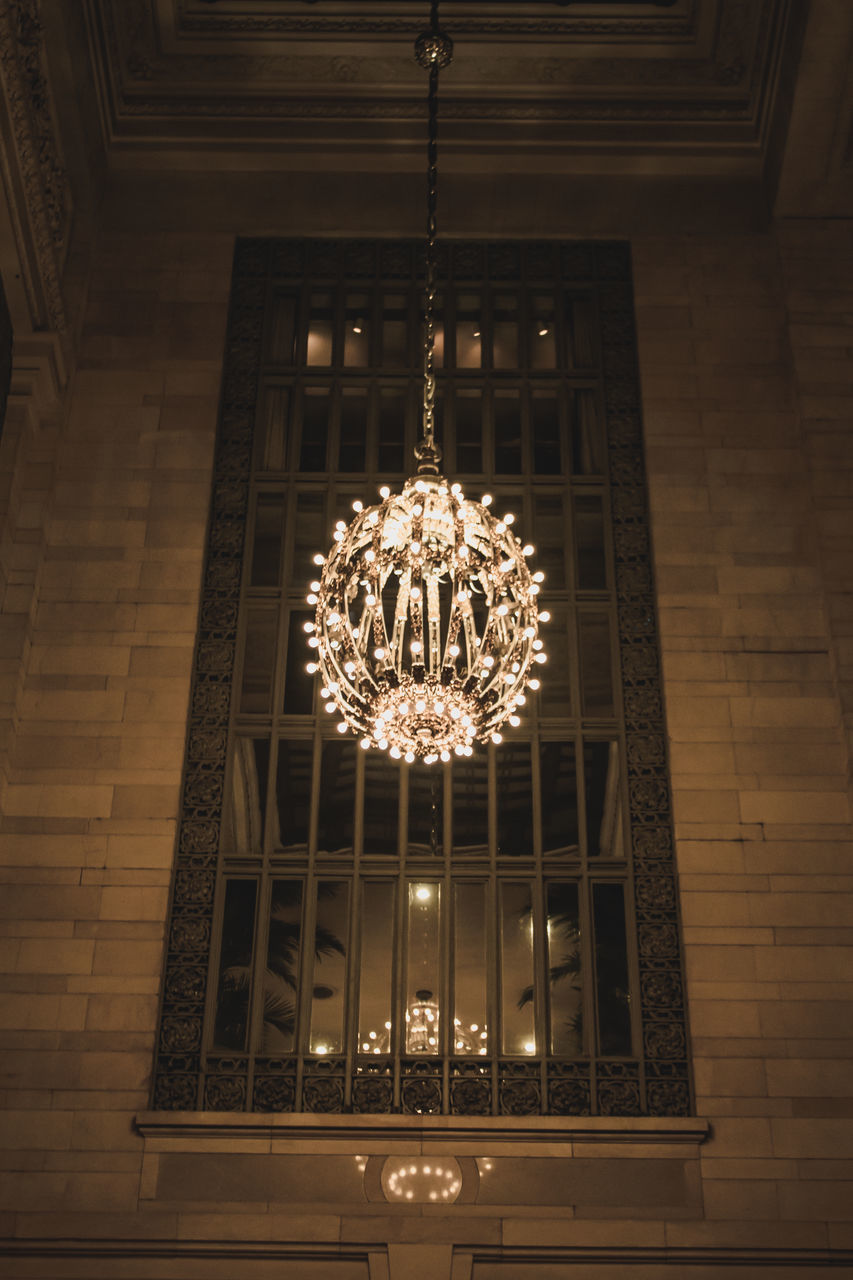 DIRECTLY BELOW SHOT OF ILLUMINATED CHANDELIER HANGING ON CEILING