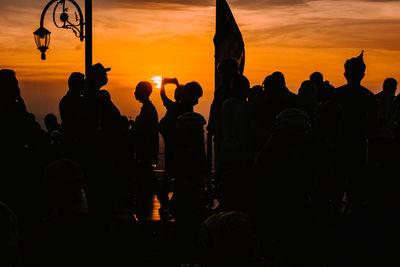 Silhouette people at sunset