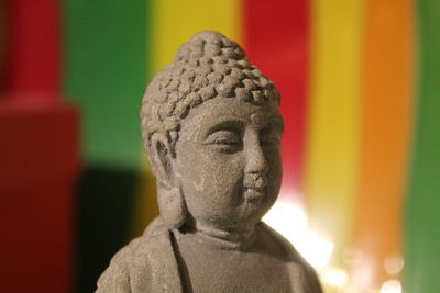 Close-up of buddha statue in sunny day