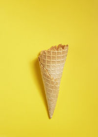Close-up of ice cream over yellow background