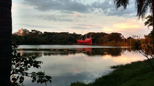 Scenic view of lake against sky at sunset