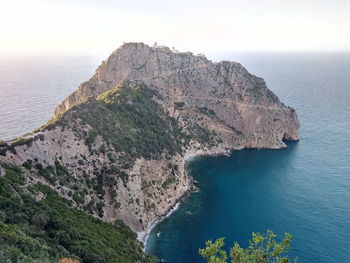 High angle view of rocks by sea against sky