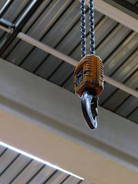 Low angle view of hook hanging against ceiling
