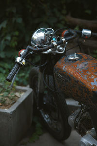 High angle view of abandoned vintage motorcycle by plants