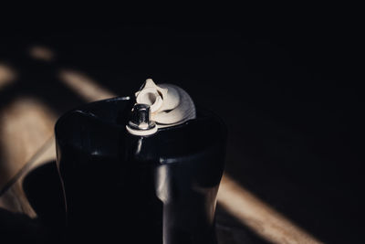 Close-up of drink served on table against black background