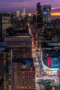 High angle view of illuminated buildings against sky at night