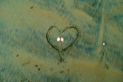 Close-up of heart shape on beach