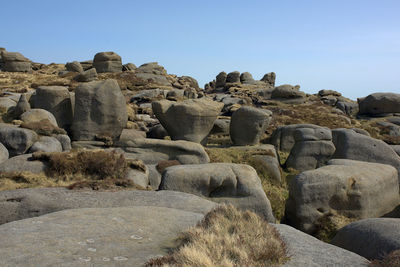 Low angle view of rocks against clear sky