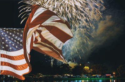 American flag and buildings against sky during independence day celebration