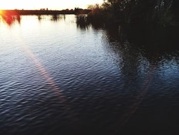 Scenic view of lake at sunset