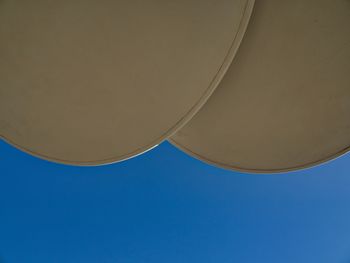 Low angle view of electric lamp against blue sky