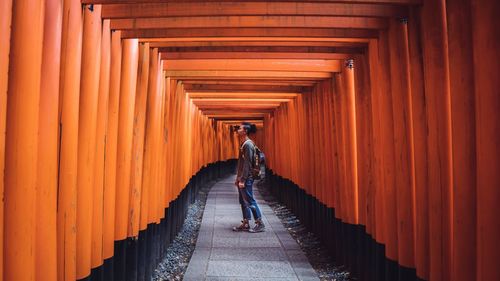 Rear view of man walking in corridor