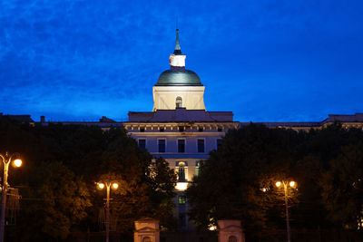 Low angle view of illuminated building against blue sky