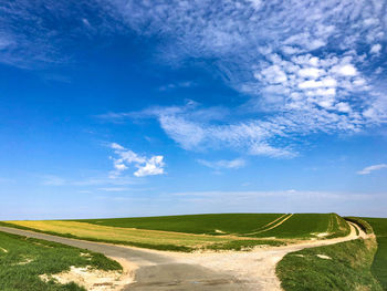 Scenic view of landscape against blue sky