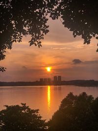 Scenic view of lake against orange sky