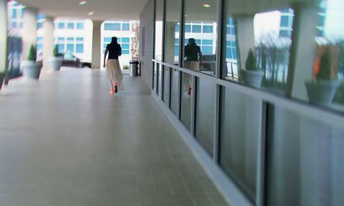 Rear view of people walking in corridor