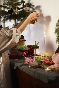 Woman decorating house for christmas