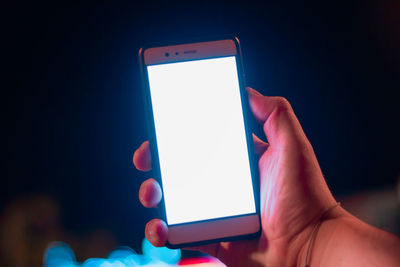 Close-up of hand holding mobile phone