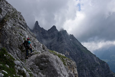 Low angle view of man rock climbing