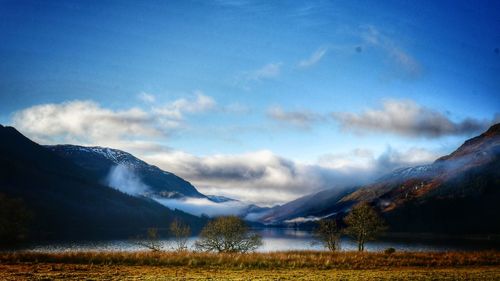 Scenic view of lake and mountains against sky