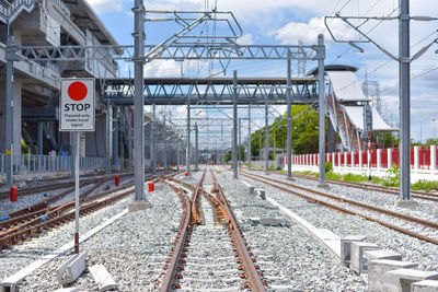 Railroad tracks in city against sky