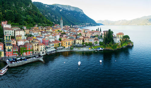 Scenic view of town by sea