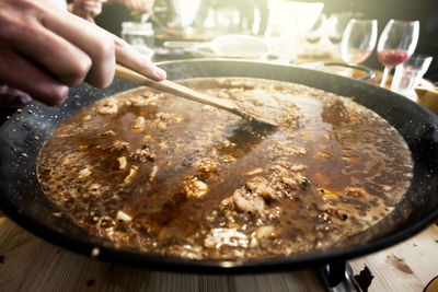 Close-up of person preparing food on table